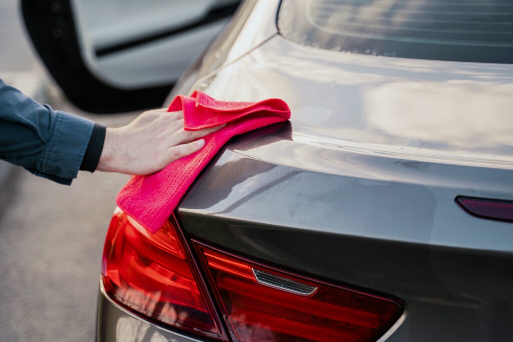 man trying a waterless carwash